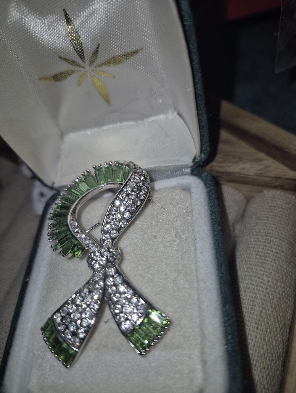 Silver Ribbon Brooch with Green Crystal Accents